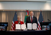 Alicia Bárcena and Zeldin hold up copies of a signed agreement to fund sewage treatment for the Tijuana River