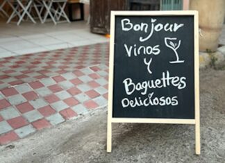 A billboard outside an open restaurant