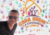 A man in sunglasses in front of a building entrance sign reading Casa Hogar La Esperanza de Loreto