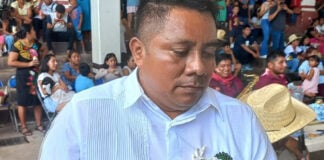 Man in white shirtholding a caiman