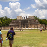 Tourists walk around the Chichén Itzá pyramids in Yucatán Mexico