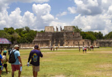 Tourists walk around the Chichén Itzá pyramids in Yucatán Mexico