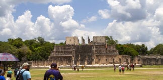 Tourists walk around the Chichén Itzá pyramids in Yucatán Mexico