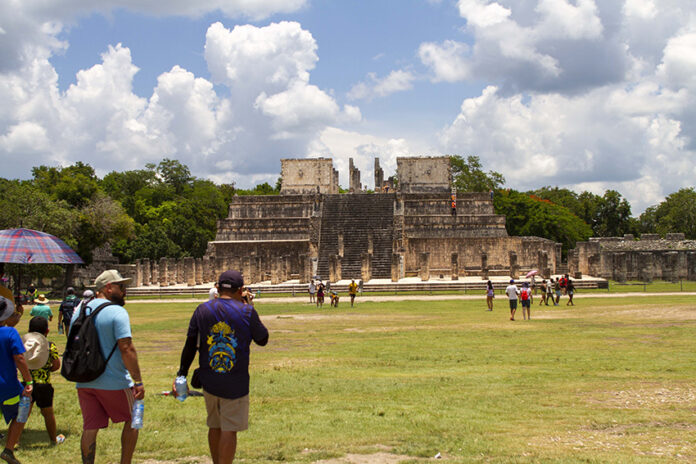 Tourists walk around the Chichén Itzá pyramids in Yucatán Mexico