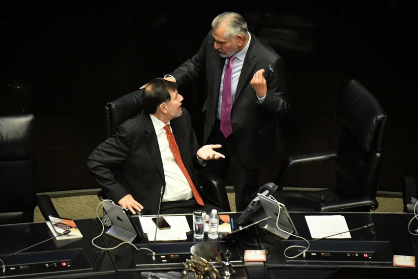Gerardo Fernández Noroña, president of the Mexican Senate's board of directors, and Mexican Senator Adán Augusto have a discussion on the Senate floor