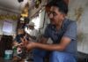 man crafting a sandal