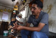 man crafting a sandal