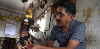 man crafting a sandal