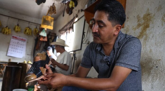 man crafting a sandal