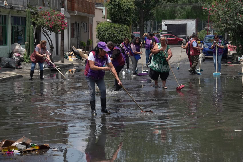 peope cleaning up after rain