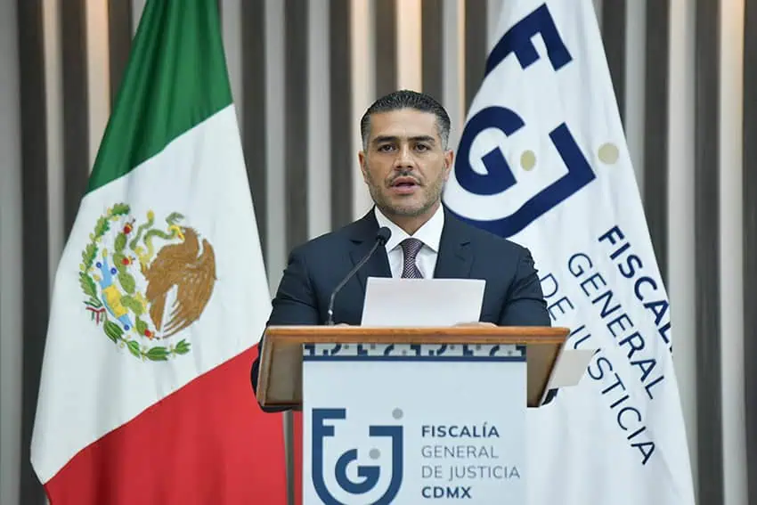 Security Miniser Omar García Harfuch at a podium with a Mexican flag