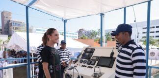 Preisdent with boat crew