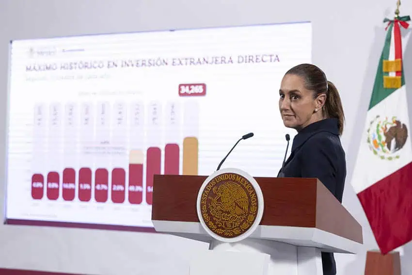 Sheinbaum next to a slide showing foreign direct investment in Mexico growing in recent years