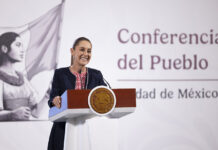 President Claudia Sheinbaum at a podium in front of the worlds "Conferencia del Pueblo"