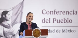 President Claudia Sheinbaum at a podium in front of the worlds "Conferencia del Pueblo"