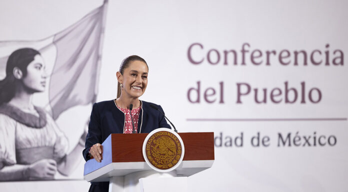 President Claudia Sheinbaum at a podium in front of the worlds "Conferencia del Pueblo"
