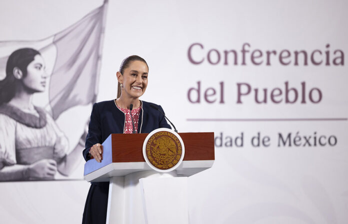 President Claudia Sheinbaum at a podium in front of the worlds 
