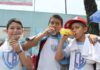Three schoolboys drinking sugared drinks