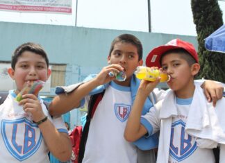 Three schoolboys drinking sugared drinks