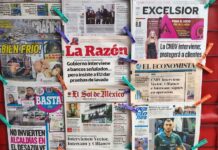 newspapers hanging up at a stand