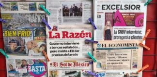 newspapers hanging up at a stand