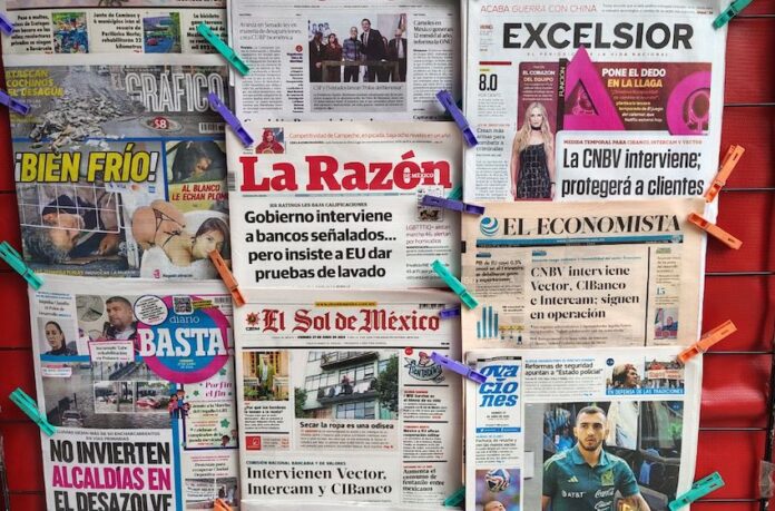 newspapers hanging up at a stand