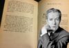 Juan Rulfo in front of a page of his book
