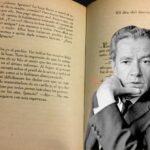 Juan Rulfo in front of a page of his book
