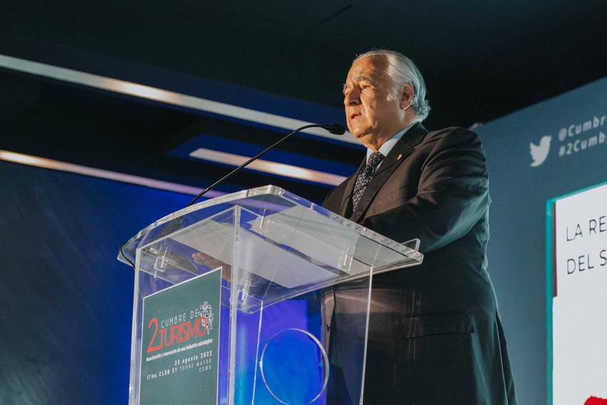 Mexico's Secretary of Tourism, Miguel Torruco Marqués, delivers a speech from a podium at the 2nd Summit on Tourism, held in Mexico City on August 25, 2022.