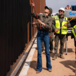 Kirsti Noem painting the border wall