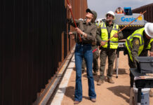 Kirsti Noem painting the border wall