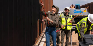 Kirsti Noem painting the border wall