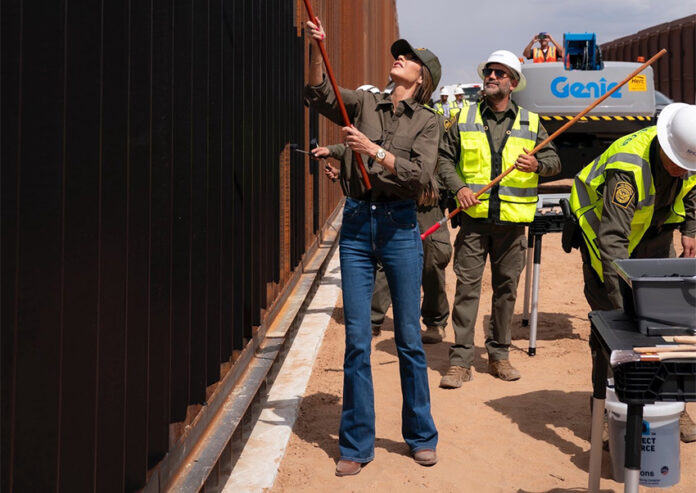 Kirsti Noem painting the border wall