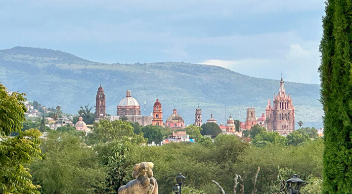 The San Miguel de Allende skyline visible behind a green park full of trees