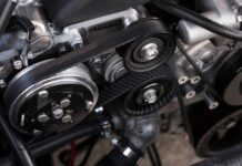 A closeup shot of auto parts: a car's timing belt and engine
