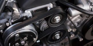 A closeup shot of auto parts: a car's timing belt and engine
