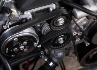 A closeup shot of auto parts: a car's timing belt and engine