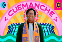 Photo of designer Mario Cortés smiling warmly, wearing glasses and an orange and purple FIFA Mexico City official scarf. The photo is set against a vibrant, stylized graphic background that features his artistic name, "CUEMANCHE," in large pink letters above a colorful sunburst design.