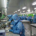 Employees at work in a drug manufacturing facility