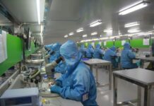 Employees at work in a drug manufacturing facility