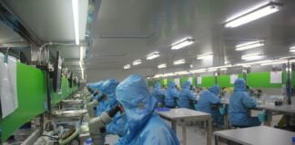 Employees at work in a drug manufacturing facility
