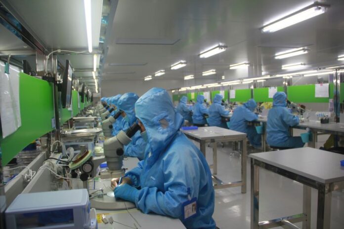 Employees at work in a drug manufacturing facility