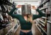 A woman with a pan on her head standing in a supermaret aisle