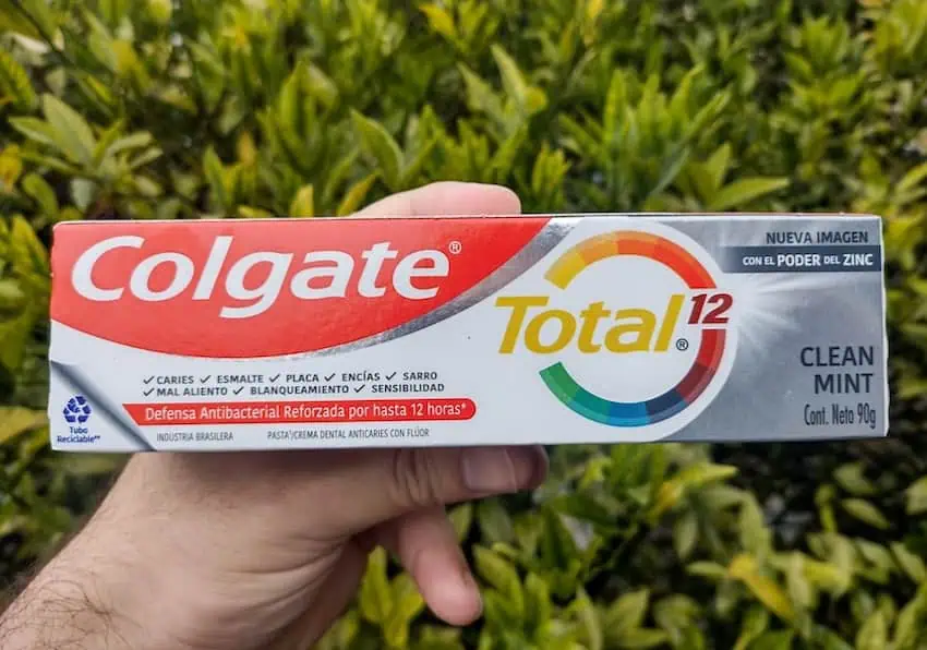 hand holding toothpaste tube