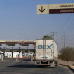 A semi trailer appraoches customs at a land border crossing