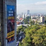 Greenpeace banner hanging from Estela de Luz that says "La Selva Maya Grita!"