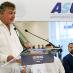 Fernando Chico Pardo stands at a podium at Veracruz airport in front of a sign reading ASUR
