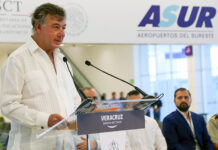 Fernando Chico Pardo stands at a podium at Veracruz airport in front of a sign reading ASUR