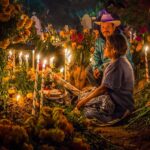 An elderly couple at a grave during Day of the Dead in Oaxaca