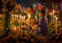 An elderly couple at a grave during Day of the Dead in Oaxaca